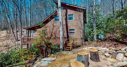 Mountain home nestled in the forest with a stream, deck, firepit, & game room