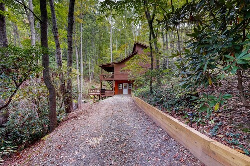 Mountain home nestled in the forest with a stream, deck, firepit, & game room