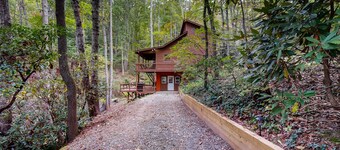 Mountain home nestled in the forest with a stream, deck, firepit, & game room