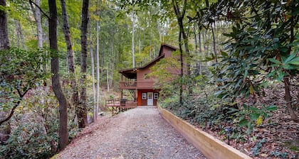 Mountain home nestled in the forest with a stream, deck, firepit, & game room