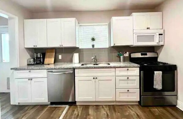 Enjoy cooking in this well-equipped kitchen with a microwave and oven, along with a convenient dishwasher.