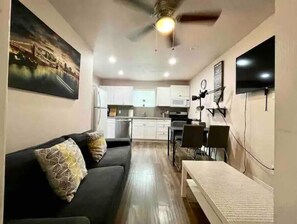 Cozy living space with a sofa, table, and flat-screen TV.