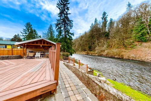 Dog-friendly riverfront home with patio, golf nearby, enclosed yard, & W/D