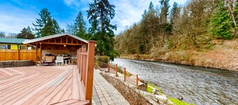 Dog-friendly riverfront home with patio, golf nearby, enclosed yard, & W/D