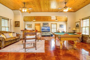 A spacious room with a pool table, wooden ceiling, and multiple ceiling fans. - Mucho Gusto in Bandera (Bandera)