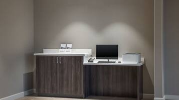 A reception desk with a computer, a phone, and a sign that reads "Marriott Bonvoy."