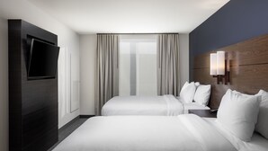 A hotel room with two beds, a TV mounted on the wall, a bedside table with a lamp, and a view of the outdoors through the window. - Residence Inn By Marriott Denver Aurora (Aurora)