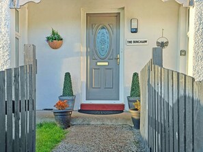 A front door with a sign reading 'THE BUNGALOW' above it. - 2 bedroom accommodation in Thropton, near Rothbury (Thropton, near Rothbury)