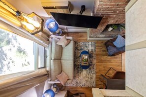 Relax in this inviting living area with a sofa, coffee table, and mounted TV.