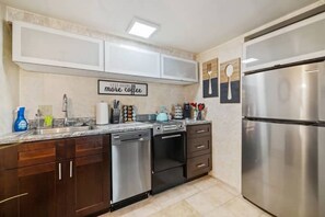Enjoy cooking in this well-equipped kitchen with a dishwasher, oven, and refrigerator.