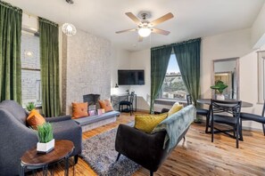 Relax in this stylish living room with a sofa, chair, and flat-screen TV.