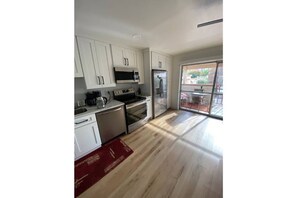 Enjoy cooking in this well-equipped kitchen with a microwave, oven, and refrigerator.