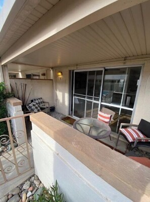 Relax in this serene outdoor space with a seating area and potted plants.