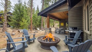 A covered outdoor seating area with Adirondack chairs, a fire pit, and a grill. - Family Friendly w/ Suncadia Pool Access (Cle Elum)