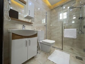 Designer toiletartikelen, een haardroger, pantoffels, een bidet