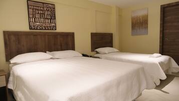 A hotel room with two beds, wooden headboards, and a large abstract artwork on the wall.