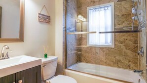 A bathroom with a glass-enclosed shower, a white toilet, and a sink with a mirror above it. - Faboulous and Cozy Apartment in Montclair, NJ (Montclair)