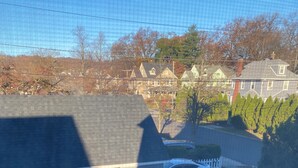 A residential area with a house featuring a patio with outdoor furniture and a covered seating area. - Faboulous and Cozy Apartment in Montclair, NJ (Montclair)