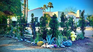 A garden with various plants and a yellow fire hydrant.