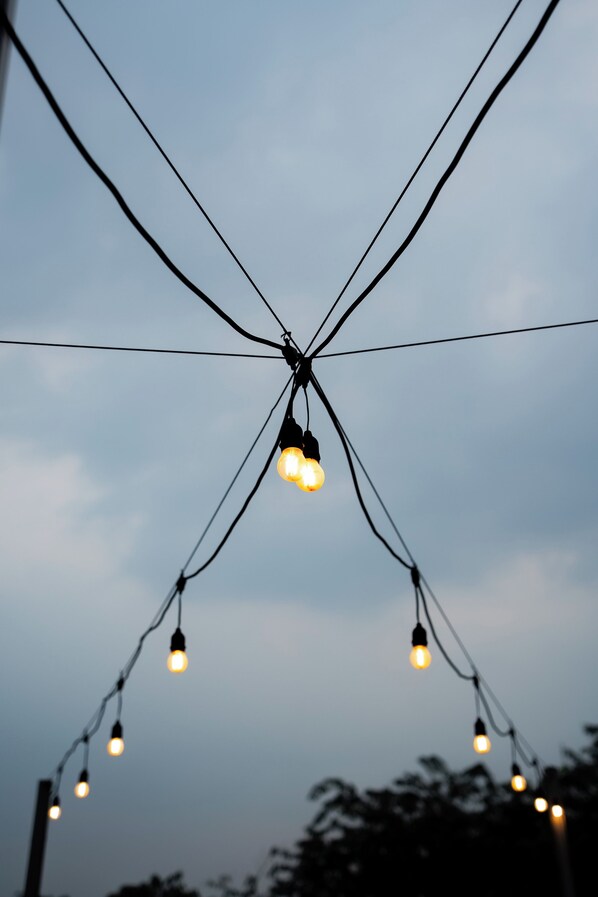 A string of lights against a cloudy sky.