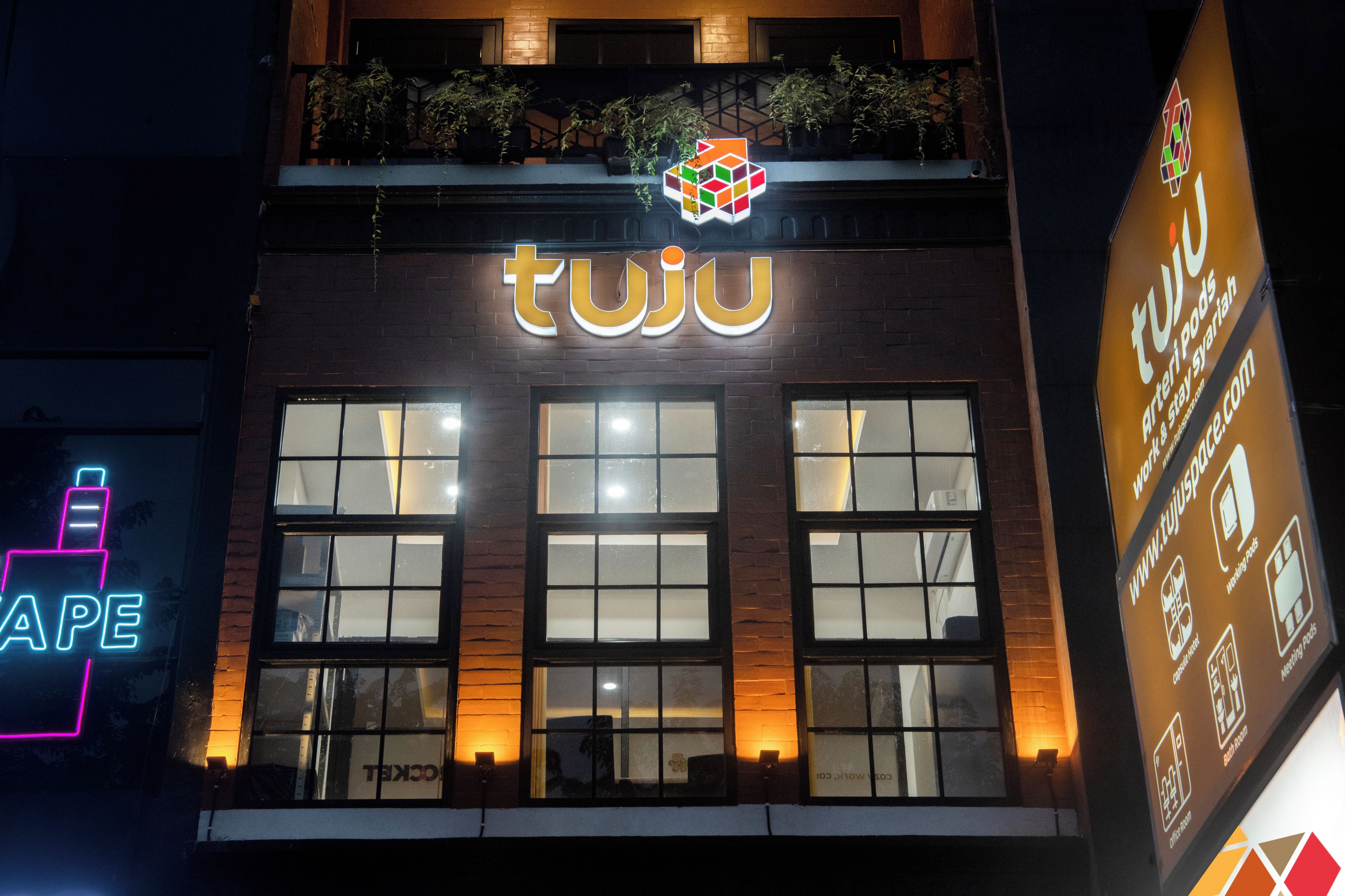 A building with a prominent 'tuju' sign above the entrance.
