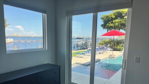 A room with a view of a swimming pool and a dock. - Waterfront oasis, sunsets, heated pool, hot tub, boat dock, near boat ramp (Bradenton)