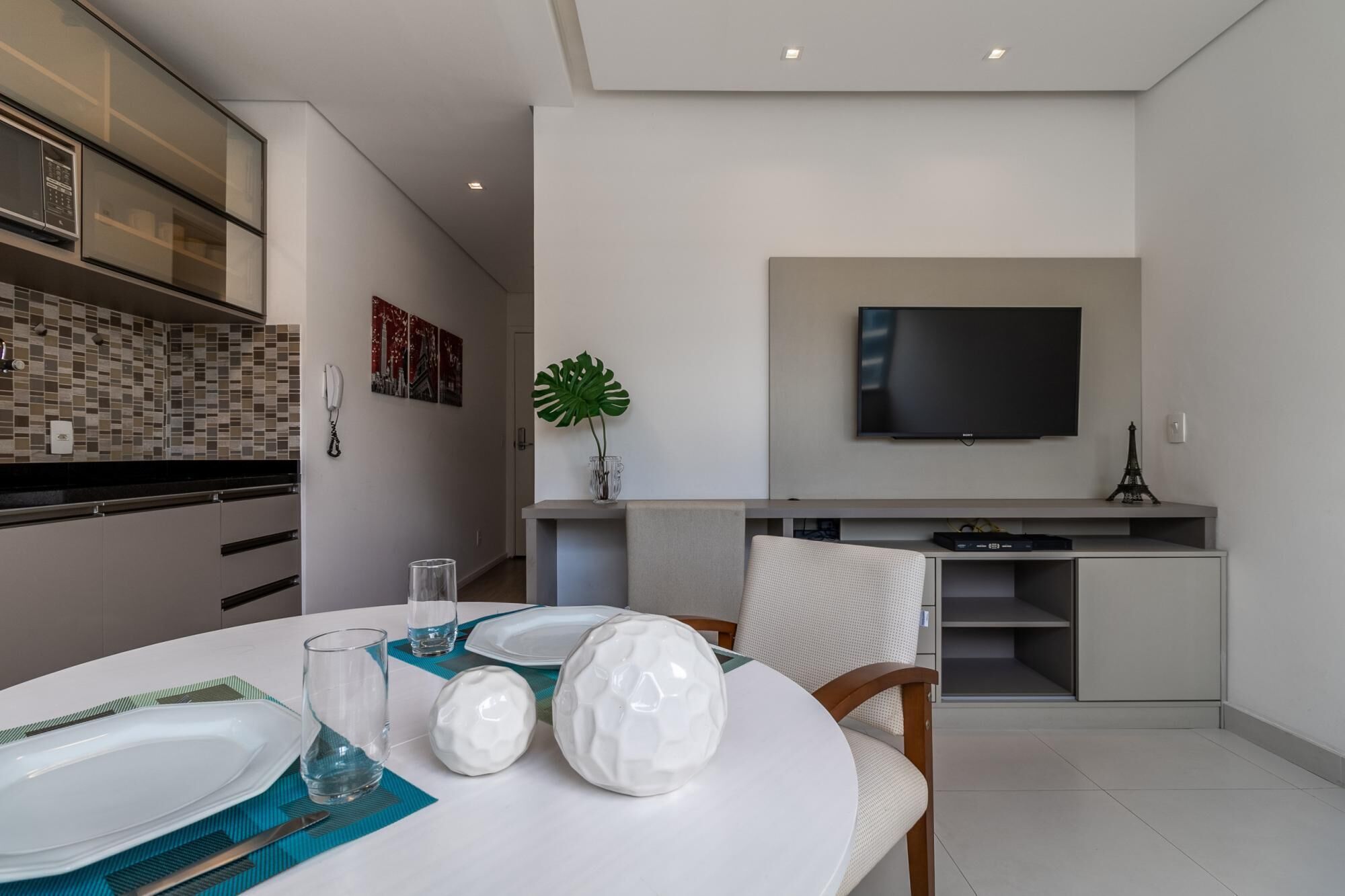 A modern kitchen with a dining area.