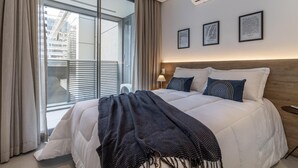 A hotel room with a large bed, a window with curtains, and three framed maps on the wall. - HW Rebou As2636-210 (São Paulo)