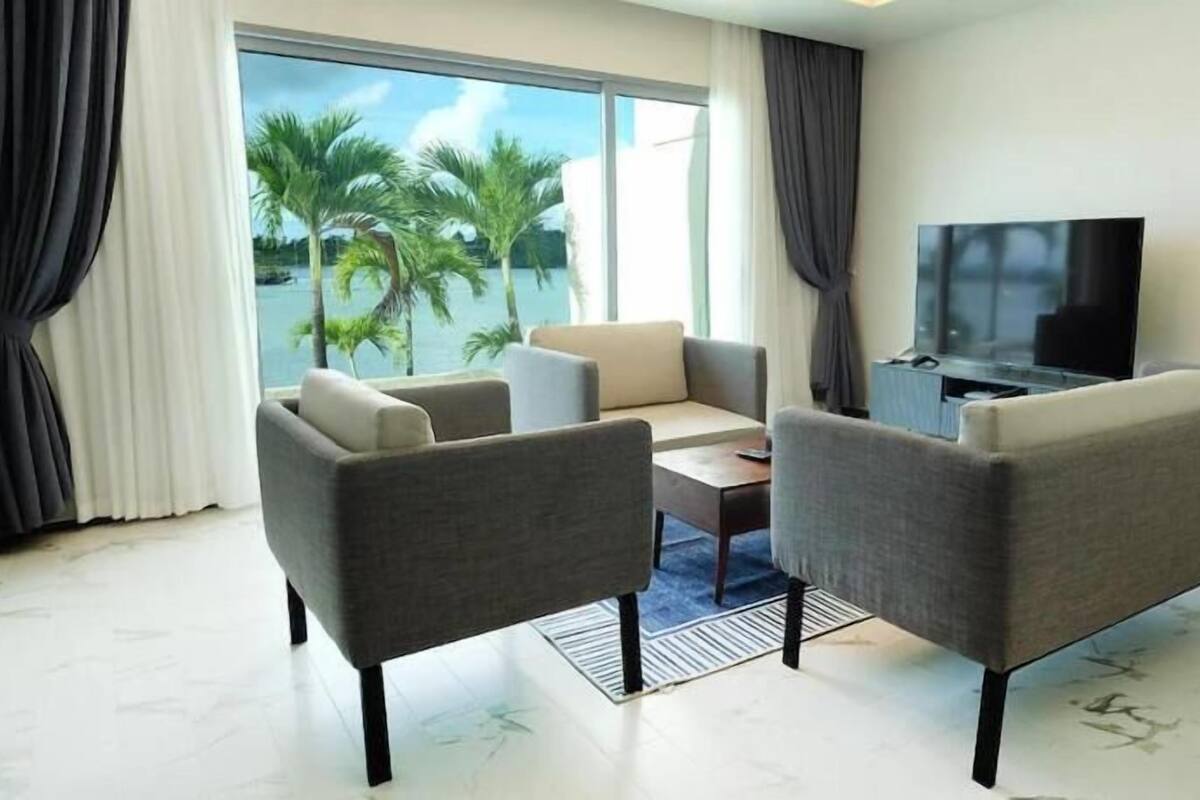 A modern living room with two sofas, a coffee table, and a TV.