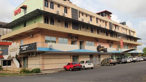 A multi-story building with a prominent 'OYO' sign on the facade, featuring a flat roof and multiple balconies. - Sandakan Inn (Sandakan)