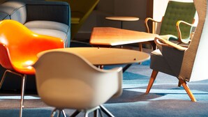 A modern interior with a blue sofa, a white chair, and a green armchair. - WPÜ HOTEL SHINJUKU (Tokyo)