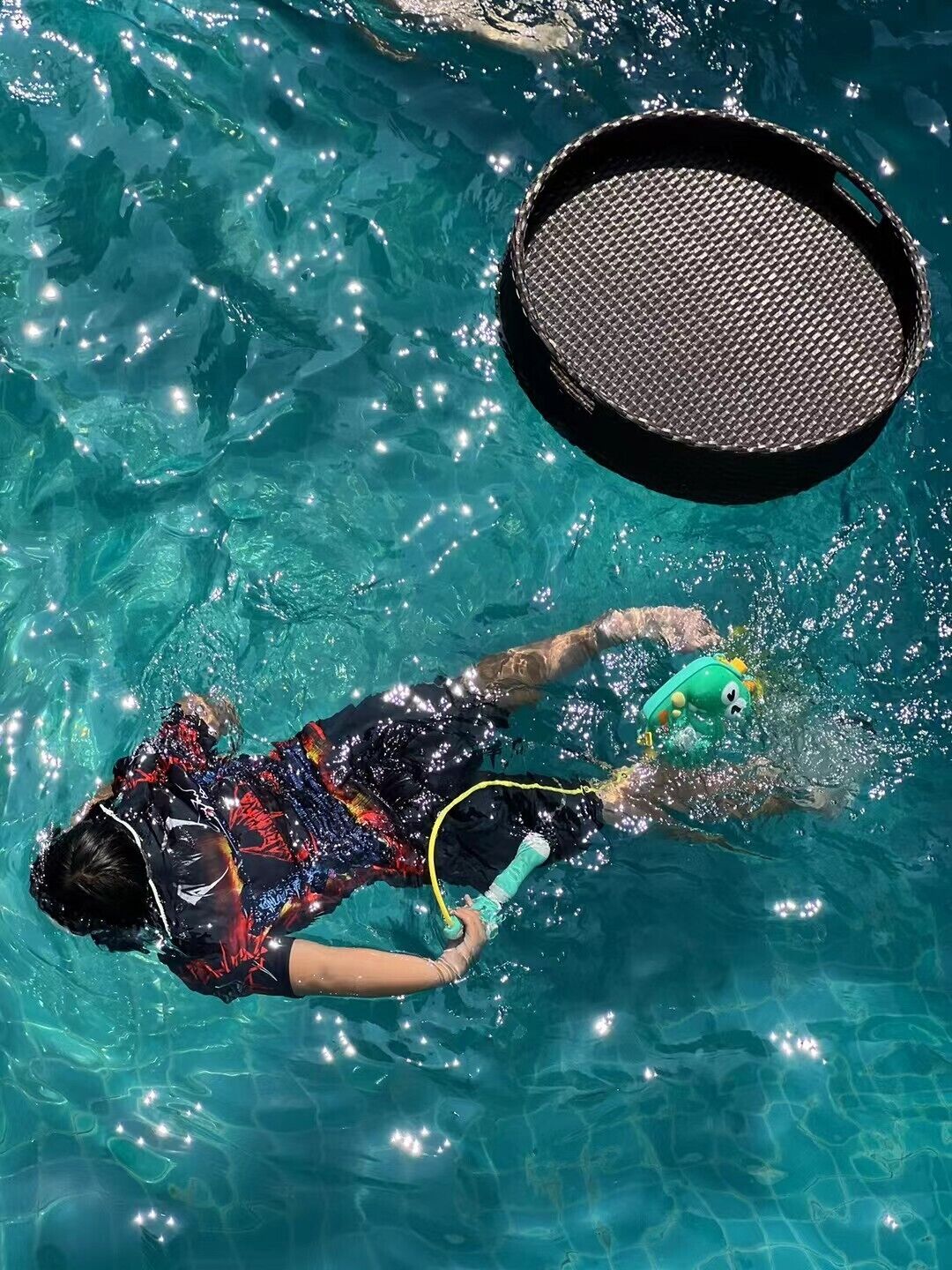 Iemand zwemt in een zwembad met snorkel en duikmasker.