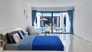 A modern bedroom with a large bed, a view of a pool, and a bright, spacious room.