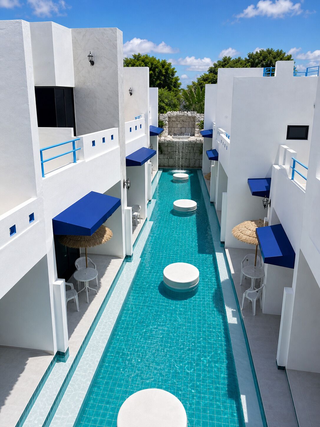 A narrow pool with blue-tiled sides, white walls, and blue accents.