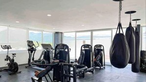 A gym with cardio machines, weightlifting equipment, and hanging punching bags. - Beach and Mountain View, pool.  (Puerto Vallarta)