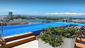 A rooftop pool with a view of a cityscape and mountains in the distance. - Beach and Mountain View, pool.  (Puerto Vallarta)