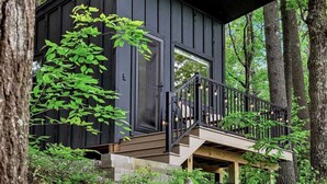 A cabin with a balcony, surrounded by trees. - Waterfront ADK Cabin and 2 Micro-cabins (Corinth)
