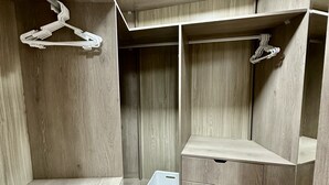 A walk-in closet with wooden paneling, multiple shelves, and hanging space. - Apartamento en San Isidro - A un paso del Golf! (San Isidro)