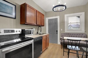 Fridge, coffee/tea maker, cookware/dishes/utensils, dining tables
