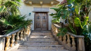 A multi-story building with a central staircase leading to a door. - Villa Serenity B&b (Sannat)