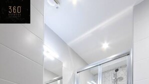 A modern bathroom with a glass-enclosed shower, a toilet, and a sink with a mirror above it. - Central hotel room, with SUPER CLEAN and COMFY BED (Saint Julian's)