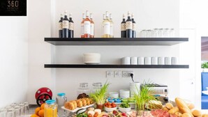 A breakfast buffet with various food items, drinks, and wine bottles. - Central hotel room, with SUPER CLEAN and COMFY BED (Saint Julian's)