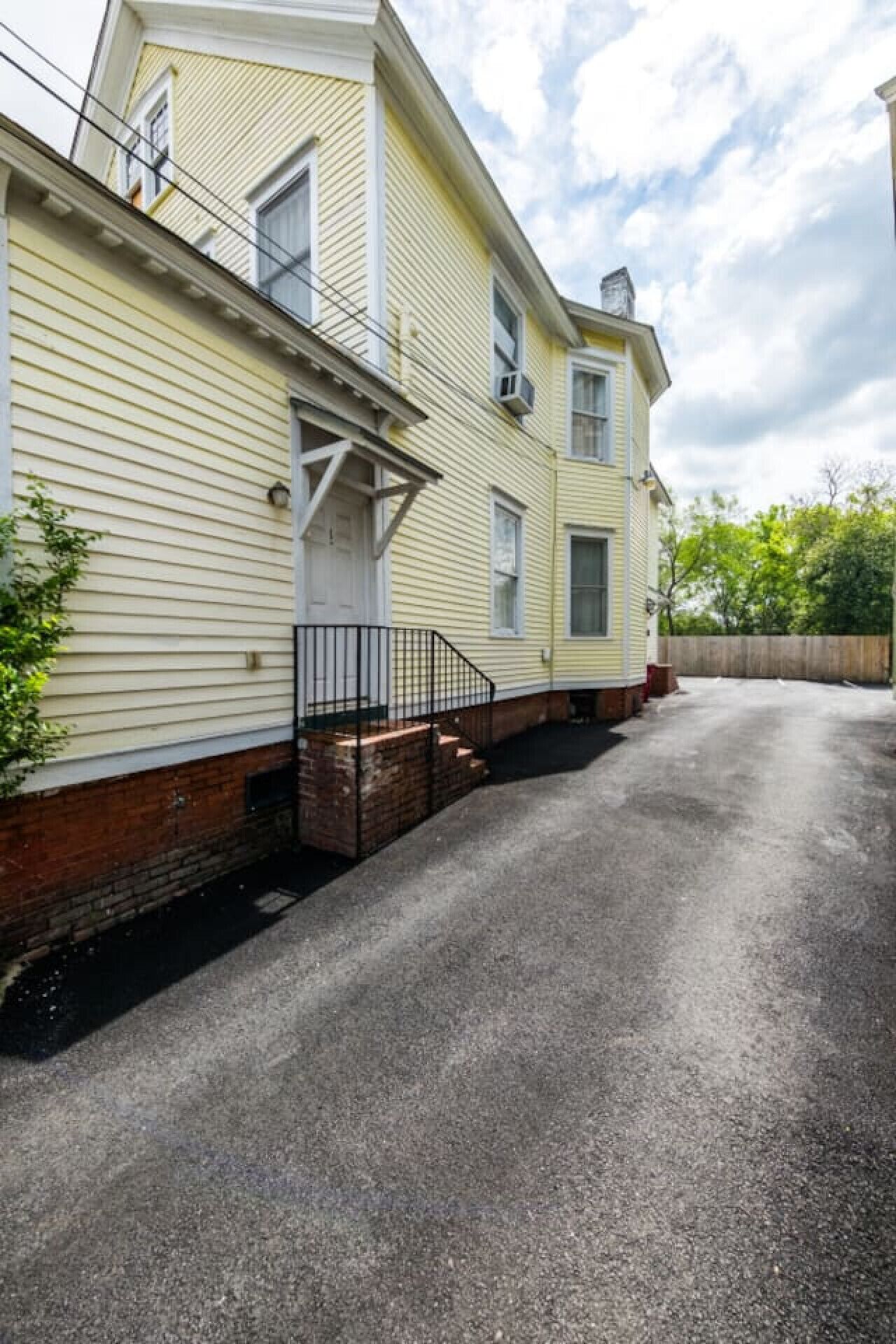 A two-story house with a front porch and a garage.