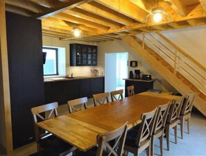 Enjoy meals in this dining area with a long table and comfortable chairs.