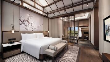 A modern bedroom with a large bed, bedside tables, a decorative wall piece, and a view through a partition.