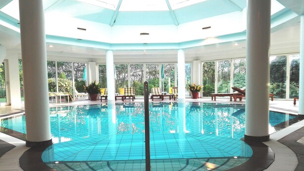 Kolam renang indoor, dengan payung kolam renang dan kursi berjemur