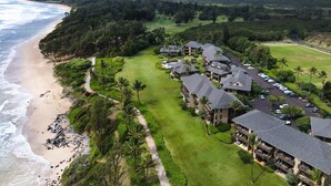 Un resort con accesso diretto alla spiaggia, un campo da golf e una rigogliosa vegetazione.