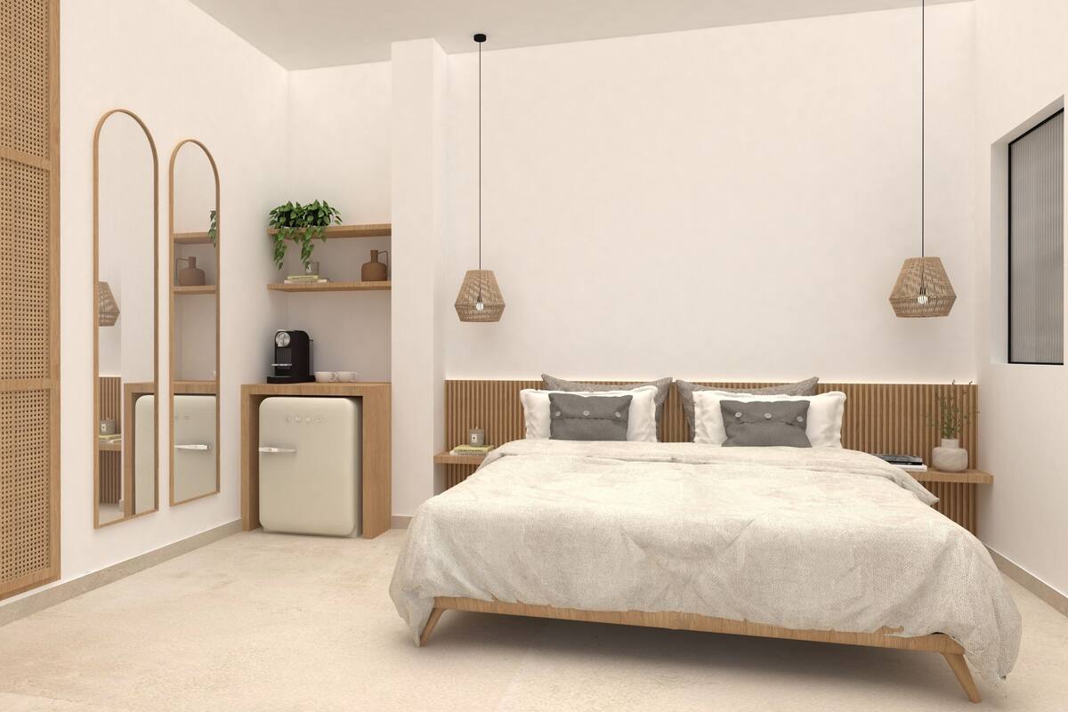 Een moderne slaapkamer met een bed, nachtkastjes, een koffiezetapparaat en een kleine koelkast.