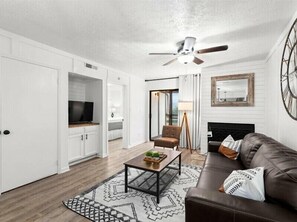 Relax in this stylish living room with a leather sofa, coffee table, and patterned rug.
