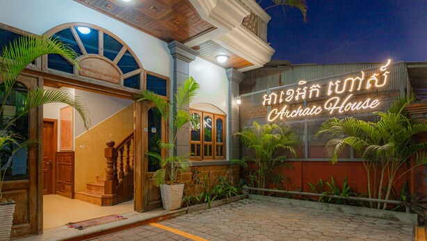 A building with a sign reading "Chai House" and a staircase leading to an entrance.